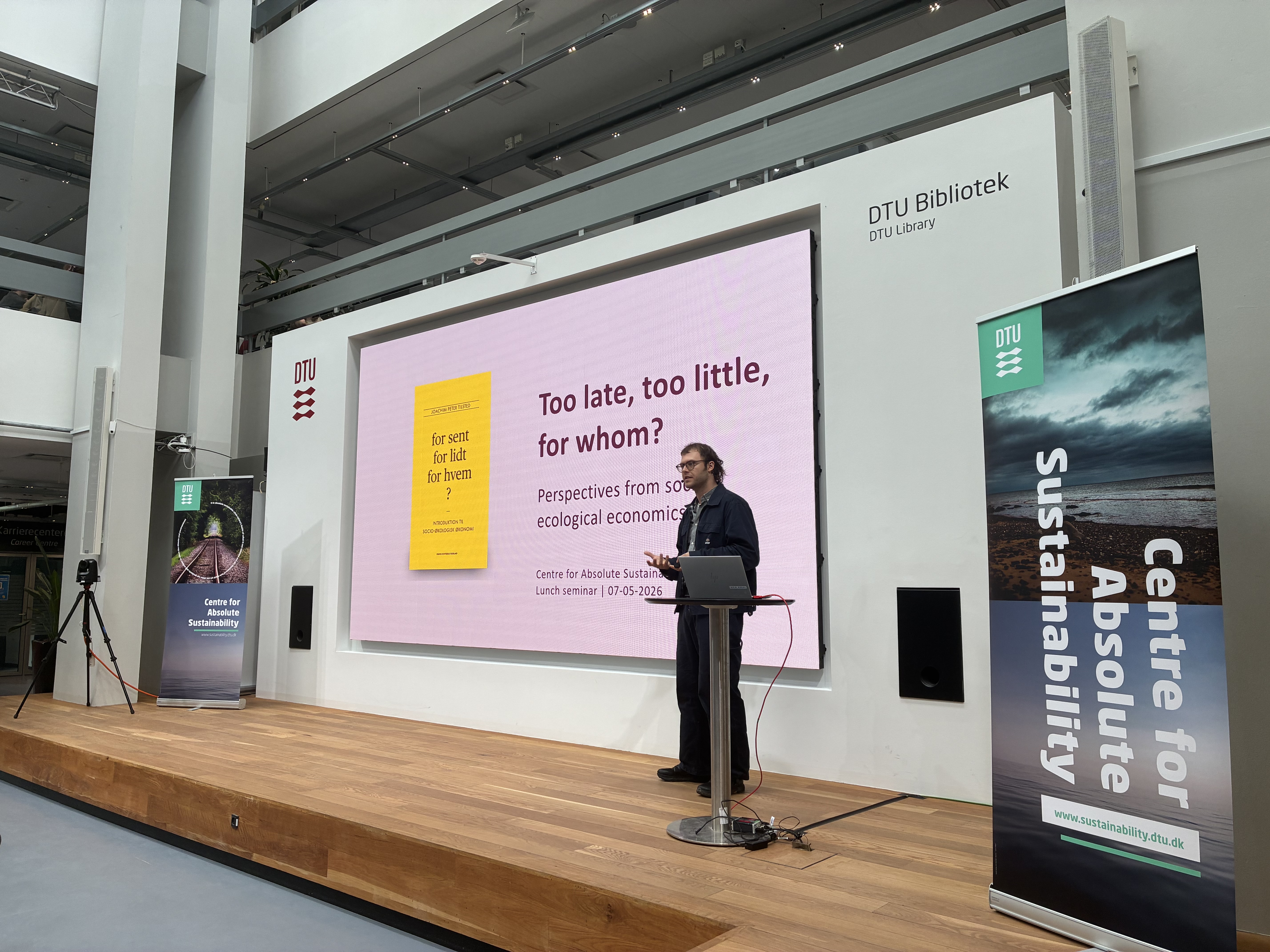 A man presents in front of a screen