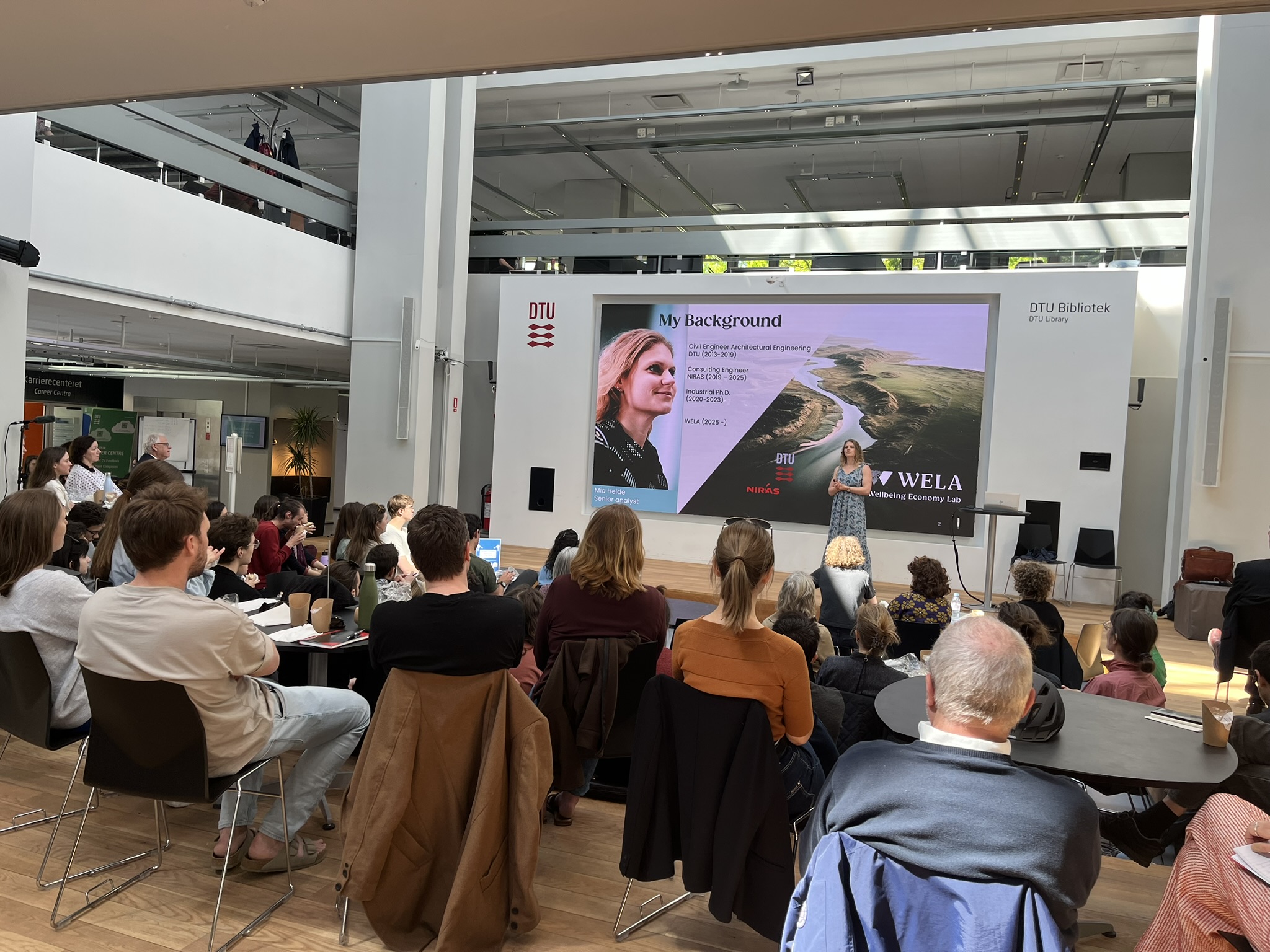 A woman presents to a crowd