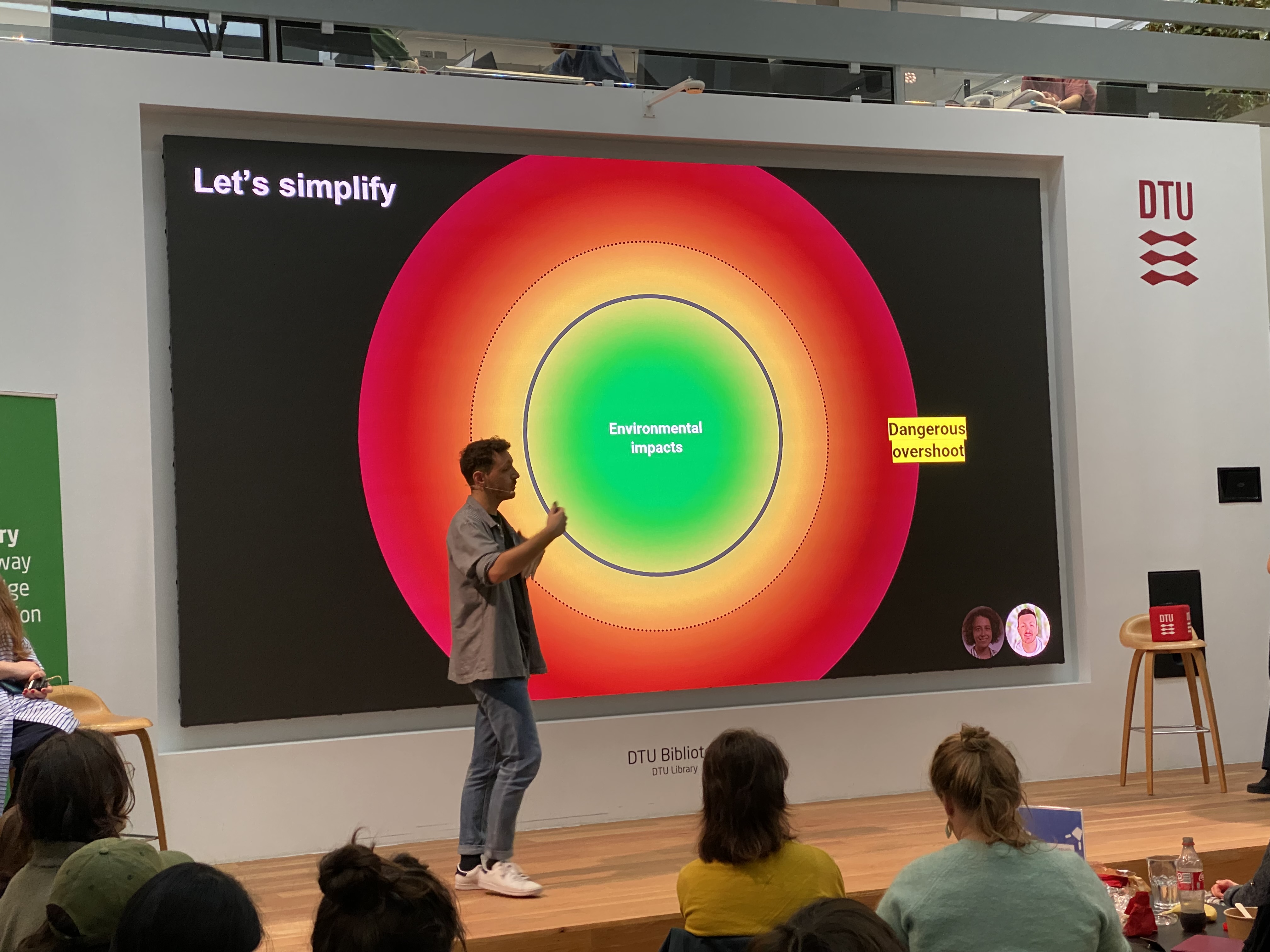A photo of man presenting to a live audience 